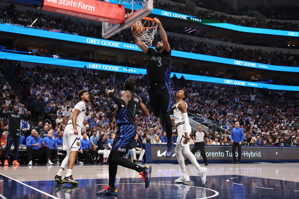 Dallas Mavericks forward Anthony Davis (3) dunks during the third quarter of an NBA basketball game against the Denver Nuggets Tuesday, Dec. 23, 2025, in Dallas. (AP Photo/Sam Hodde)