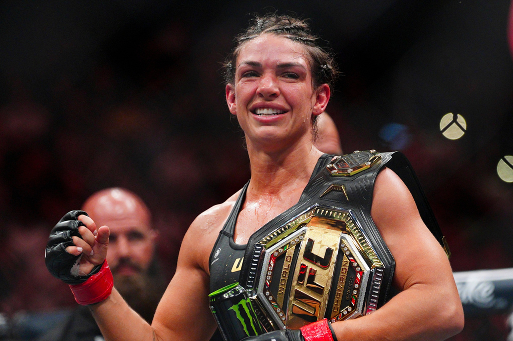 Mackenzie Dern celebrates after a women's strawweight title fight against Gillian Robertson at the UFC 330 mixed martial arts event Saturday, Aug. 15, 2026, in Philadelphia. (AP Photo/Derik Hamilton)