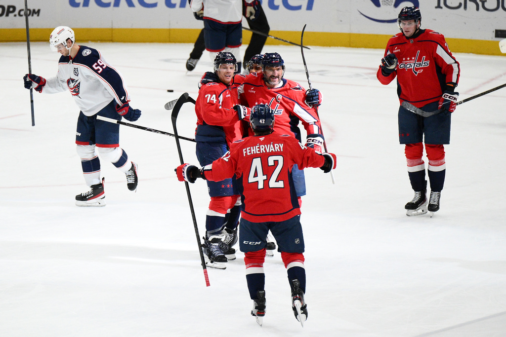 Washington Capitals defenseman John Carlson (74) celebrates his goal with teammates during the second period of an NHL hockey game against the Columbus Blue Jackets, Monday, Nov. 24, 2025, in Washington. (AP Photo/Nick Wass)