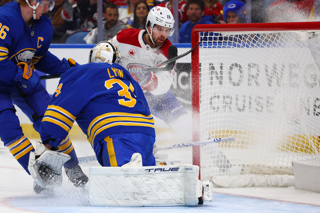 Montreal Canadiens center Alex Newhook (15) puts the puck past Buffalo Sabres goaltender Alex Lyon (34) during the second period in Game 2 of a second-round NHL hockey Stanley Cup playoff series Friday, May 8, 2026, in Buffalo, N.Y. (AP Photo/Jeffrey T. Barnes)