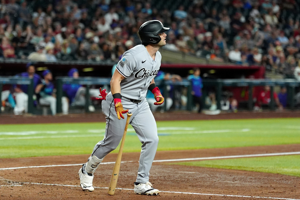 Chicago White Sox's Andrew Benintendi watches the flight of his three-run home run against the Arizona Diamondbacks during the ninth inning of a baseball game, Thursday, April 23, 2026, in Phoenix. (AP Photo/Ross D. Franklin)
