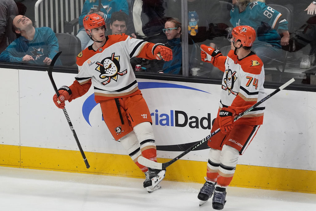 Anaheim Ducks right wing Troy Terry, left, is congratulated by defenseman John Carlson (74) after scoring against the San Jose Sharks during the third period of an NHL hockey game in San Jose, Calif., Wednesday, April 1, 2026. (AP Photo/Jeff Chiu)