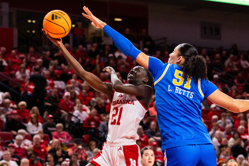 Nebraska forward Eliza Maupin (21) goes up for a layup against UCLA center Lauren Betts (51) during the first quarter of an NCAA college basketball game, Sunday, Jan. 11, 2026, in Lincoln, Neb. (AP Photo/Bonnie Ryan)
