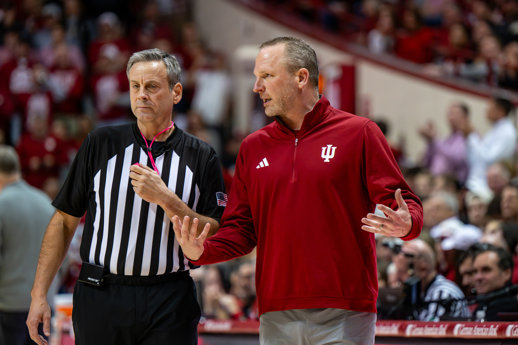 Indiana head coach Darian Devries talks with a game official during a break in the first half of an NCAA college basketball game against Purdue, Tuesday, Jan. 27, 2026, in Bloomington, Ind. (AP Photo/Doug McSchooler)