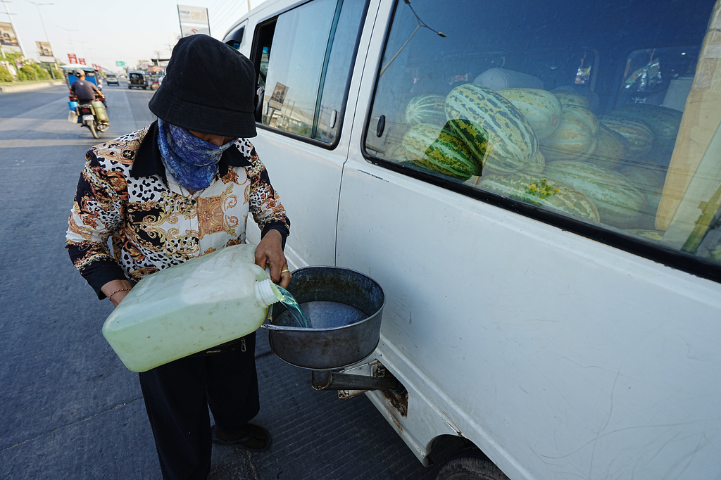 A local vendor fills up a van with diesel in Phnom Penh, Cambodia, Monday, March 30, 2026. (AP Photo/Heng Sinith)