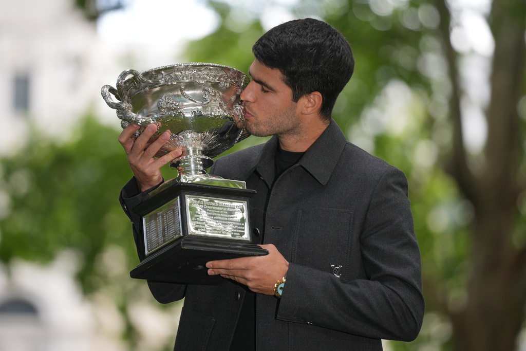 Carlos Alcaraz of Spain kisses the Norman Brookes Challenge Cup the morning after defeating Novak Djokovic of Serbia in the men's singles final at the Australian Open tennis championship, in Melbourne, Australia, Monday, Feb. 2, 2026. (AP Photo/Dita Alangkara)