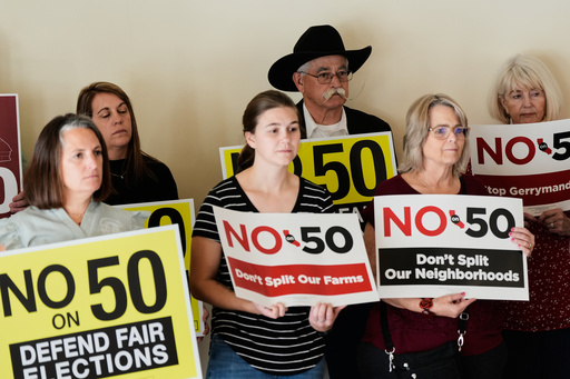 People hold up signs opposing Prop 50 during a press conference in Chico, Calif., Wednesday, Oct. 29, 2025. (AP Photo/Godofredo A. Vásquez) People hold up signs opposing Prop 50 during a press conference in Chico, Calif., Wednesday, Oct. 29, 2025. (AP Photo/Godofredo A. Vásquez)