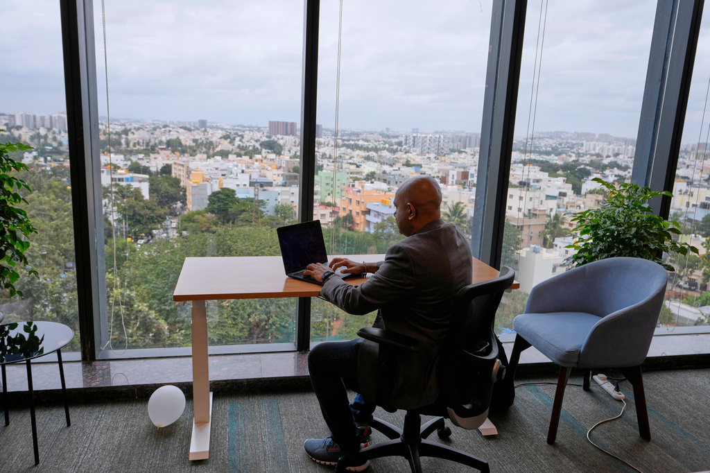 Shivaram K R, CEO of Hue Learn, works in his office with the city's skyline in the background, in Bengaluru, India, Monday, Aug. 24, 2026. (AP Photo/Aijaz Rahi)