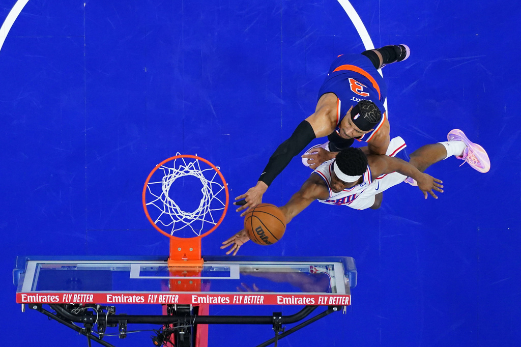 Philadelphia 76ers' Vj Edgecombe, bottom, goes up for a shot against New York Knicks' Josh Hart during the first half of Game 4 in a second-round NBA basketball playoffs series Sunday, May 10, 2026, in Philadelphia. (AP Photo/Matt Slocum)