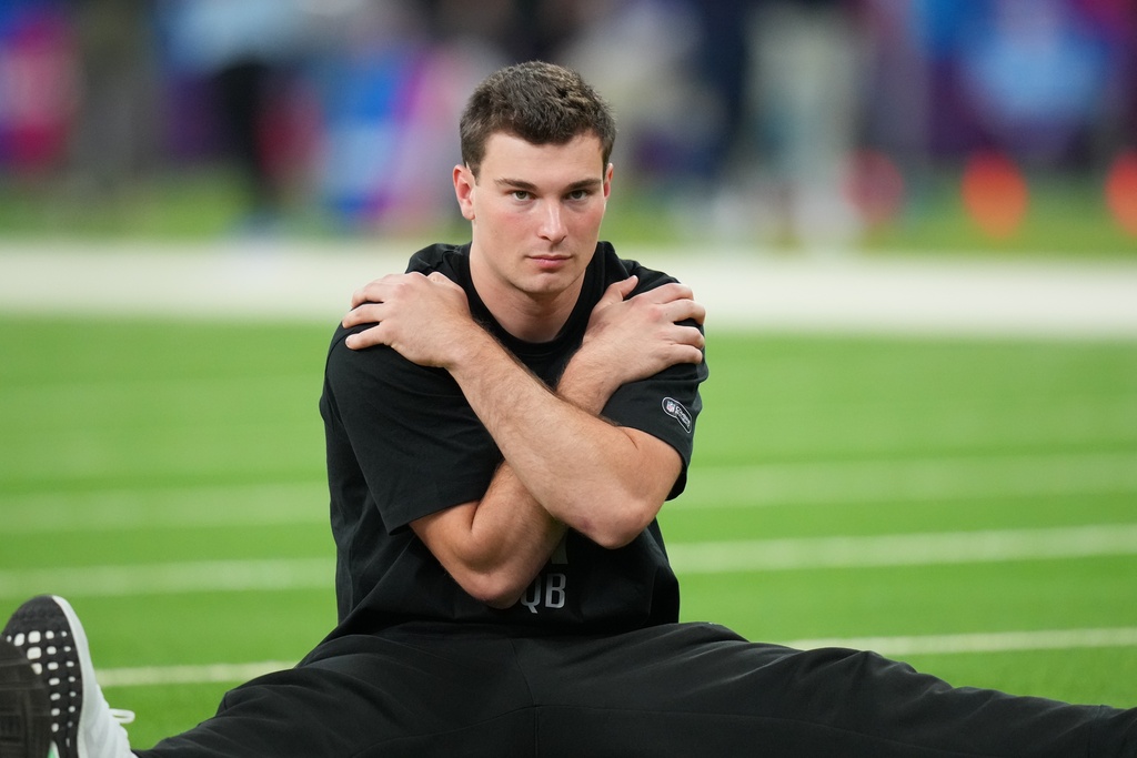 Indiana quarterback Fernando Mendoza (11) runs a drill at the NFL football scouting combine in Indianapolis, Saturday, Feb. 28, 2026. (AP Photo/Julio Cortez)