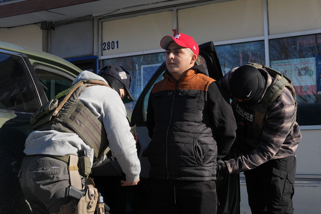A man is detained by federal agents Tuesday, Jan. 27, 2026, in Minneapolis. (AP Photo/Adam Gray)