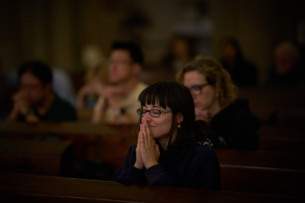 Parishioners pray during a mass in the crypt of the Sagrada Familia in Barcelona, Spain, Friday, May 15, 2026. (AP Photo/Emilio Morenatti)