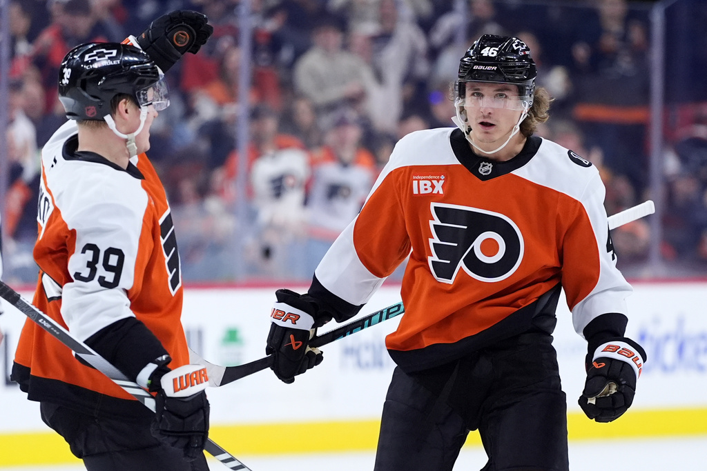 Philadelphia Flyers' Trevor Zegras, right, and Matvei Michkov celebrate after a goal by Zegras during the second period of an NHL hockey game against the Nashville Predators Thursday, Oct. 30, 2025, in Philadelphia. (AP Photo/Matt Slocum)