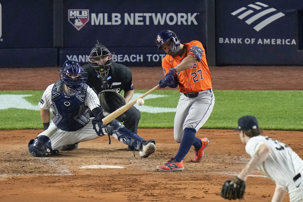 Houston Astros' Jose Altuve hits a double during the fifth inning of a baseball game against the New York Yankees Friday, Aug. 8, 2025, in New York. (AP Photo/Frank Franklin II)