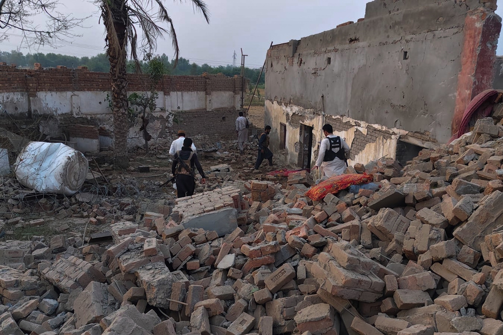 Police officers examine the site of overnight suicide bombing at a security post in Fatah Khel, in Bannu, a district in Pakistan's Khyber Pakhtunkhwa province bordering Afghanistan, Sunday, May 10, 2026. (AP Photo/Aamad Khattak)