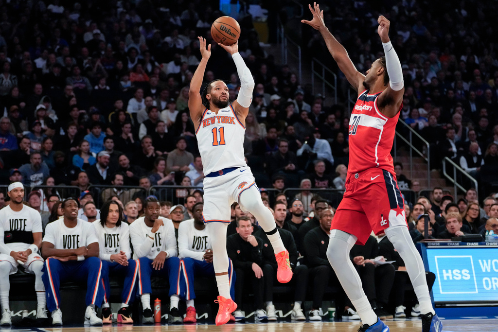 New York Knicks guard Jalen Brunson (11) shoots over Washington Wizards center Alex Sarr (20) during the first half of an NBA basketball game, Monday, Nov. 3, 2025, in New York. (AP Photo/Yuki Iwamura)