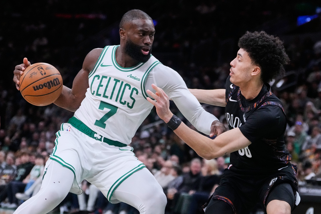 Boston Celtics guard Jaylen Brown (7) drives to the basket against Brooklyn Nets guard Nolan Traore (88) during the first half of an NBA basketball game, Friday, Feb. 27, 2026, in Boston. (AP Photo/Charles Krupa)