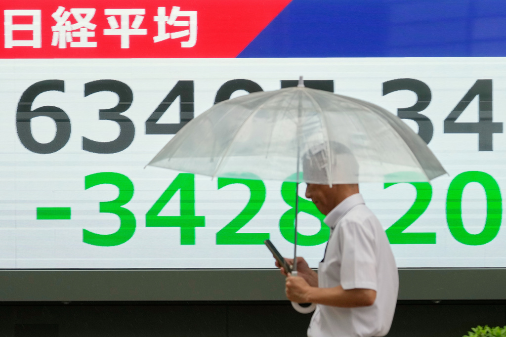 A person walks in front of an electronic stock board showing Japan's Nikkei index at a securities firm Friday, July 17, 2026, in Tokyo. (AP Photo/Eugene Hoshiko)