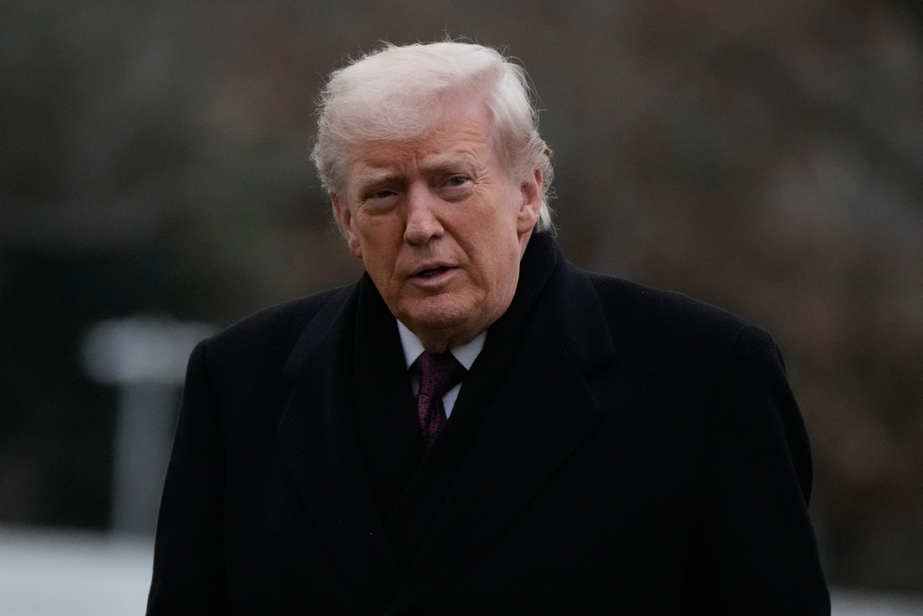 President Donald Trump looks over after stepping off Marine One on the South Lawn of the White House, Wednesday, Dec. 17, 2025, in Washington. (AP Photo/Mark Schiefelbein)