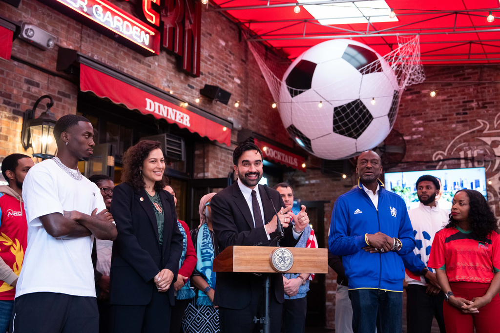 New York City Mayor Zohran Mamdani, center, joined by, from left, United States soccer star Tim Weah NYC World Cup Czar Maya Handa, and New York council member Yusef Salaam, makes a World Cup soccer tournament announcement at Harlem Tavern, Thursday, May 21, 2026 in New York. (AP Photo/Adam Gray)