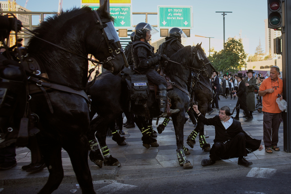 Israeli mounted police disperse Ultra-Orthodox Jews blocking a road during a protest against army draft in Jerusalem, Monday, June 1, 2026. (AP Photo/Ohad Zwigenberg)