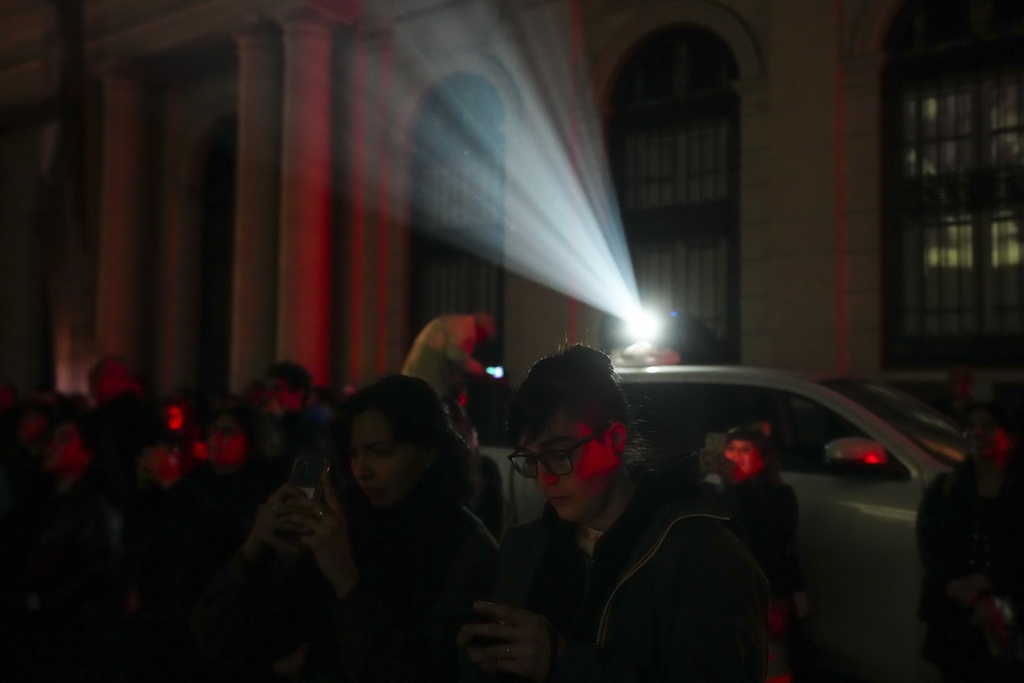 People attend an event honoring those disappeared during the regime of Gen. Augusto Pinochet, outside the Justice Palace in Santiago, Chile, Friday, Sept. 5, 2025. (AP Photo/Esteban Felix)