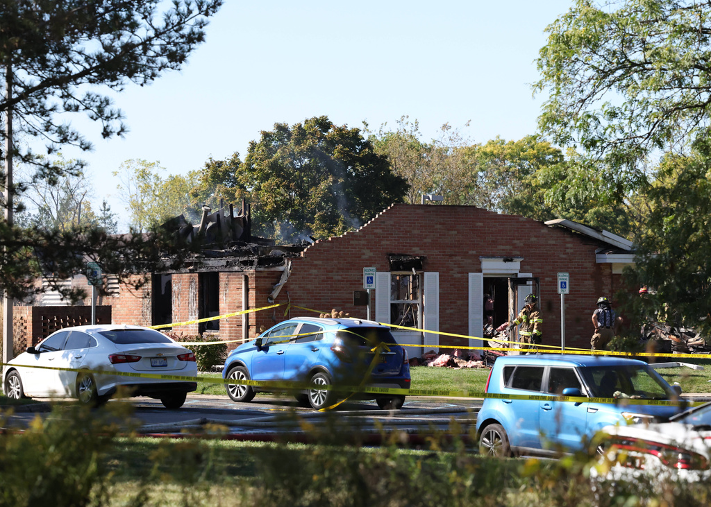 Fire and law enforcement officers stand outside the Church of Jesus Christ of Latter-day Saints, Sunday, Sept. 28, 2025 in Grand Blanc, Mich. (AP Photo/Carlos Osorio)