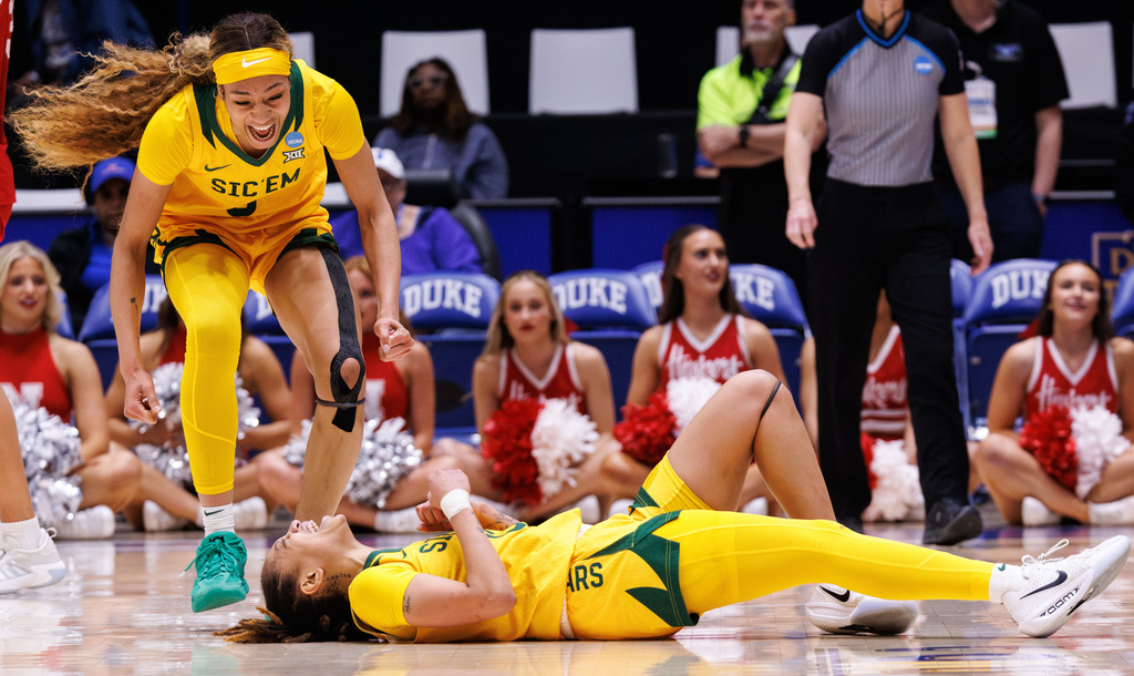 Baylor's Taliah Scott, right, and Darianna Littlepage-Buggs, left, celebrate after drawing a foul against Nebraska during the second half in the first round of the NCAA college basketball tournament Friday, March 20, 2026, in Durham, N.C. (AP Photo/Ben McKeown)