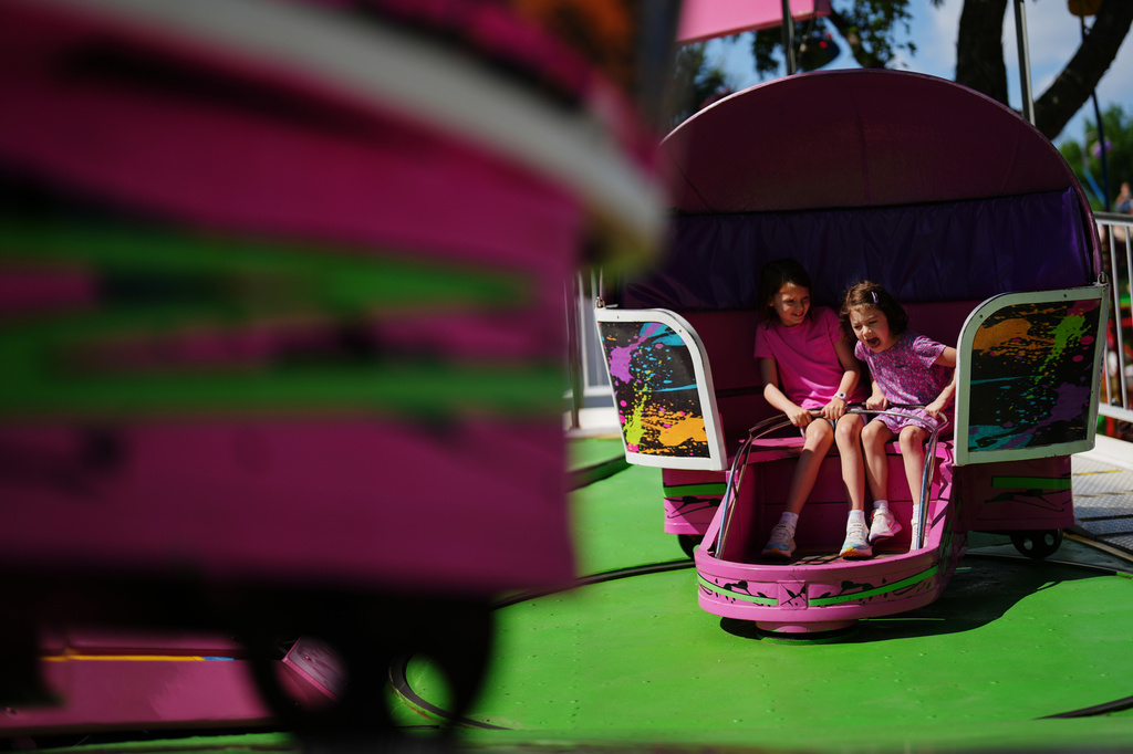 Girls ride the Tilt-A-Whirl, Thursday, Aug. 27, 2026, at the Minnesota State Fair in Falcon Heights, Minn. (AP Photo/Ellen Schmidt)