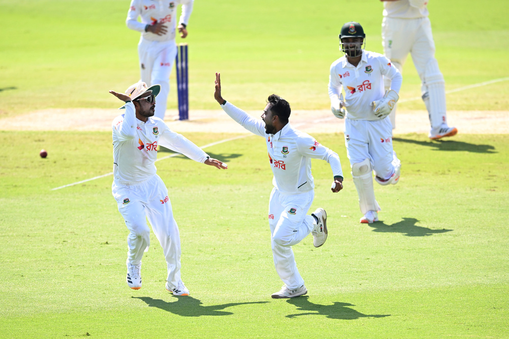 Mehidy Hasan Miraz, center, of Bangladesh celebrates with teammates after dismissing Beau Webster of Australia during play on day four of the first cricket test in Darwin, Australia, Sunday, Aug. 16, 2026. (James Ross/AAPImage via AP)