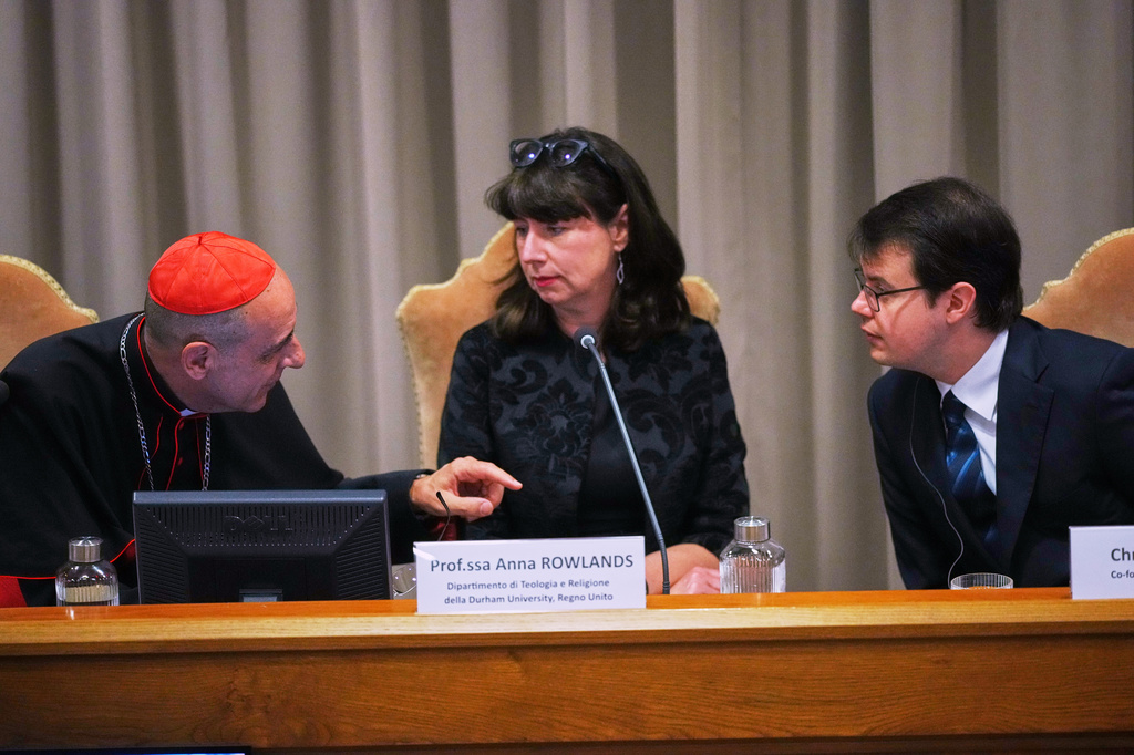 FILE - From left, Cardinal V&iacute;ctor Manuel Fern&aacute;ndez, prefect of the Dicastery for the Doctrine of the Faith, talks with theologian Anna Rowlands, and Anthropic co-founder Christopher Olah during the presentation of Pope Leo XIV's first encyclical, "Magnifica humanitas: On Safeguarding the Human Person in the Time of Artificial Intelligence," at the Vatican, May 25, 2026. (AP Photo/Alessandra Tarantino, File)