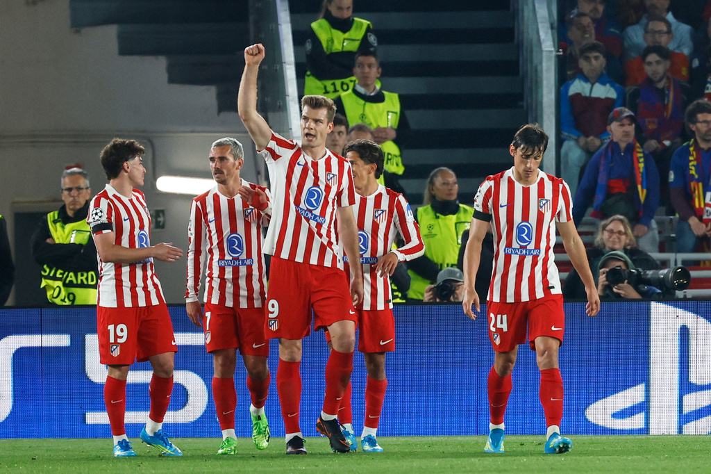 Atletico Madrid's Alexander Sorloth, centre, celebrates after scoring his side's second goal during the Champions League quarterfinal first leg soccer match between Barcelona and Atletico Madrid in Barcelona, Spain, Wednesday, April 8, 2026. (AP Photo/Joan Monfort)