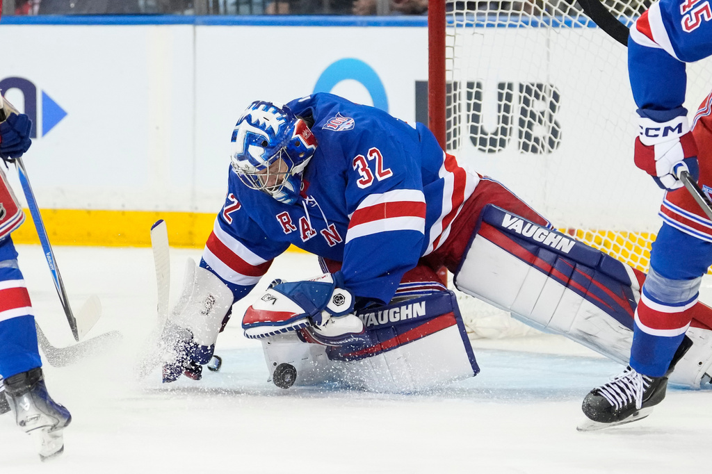 New York Rangers goaltender Jonathan Quick (32) stops the puck during the second period of an NHL hockey game against Detroit Red Wings, Saturday, April 4, 2026, in New York. (AP Photo/Yuki Iwamura)