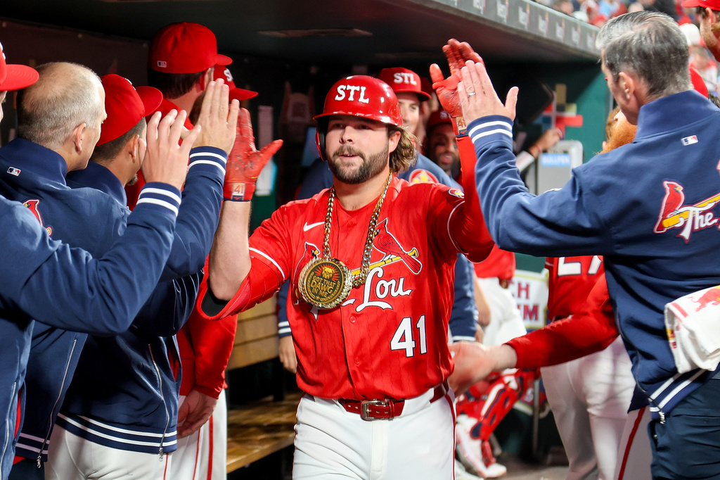 St. Louis Cardinals' Alec Burleson is congratulated by teammates after hitting a solo home run during the third inning against the Los Angeles Dodgers Friday, May 1, 2026, in St. Louis. (AP Photo/Scott Kane)