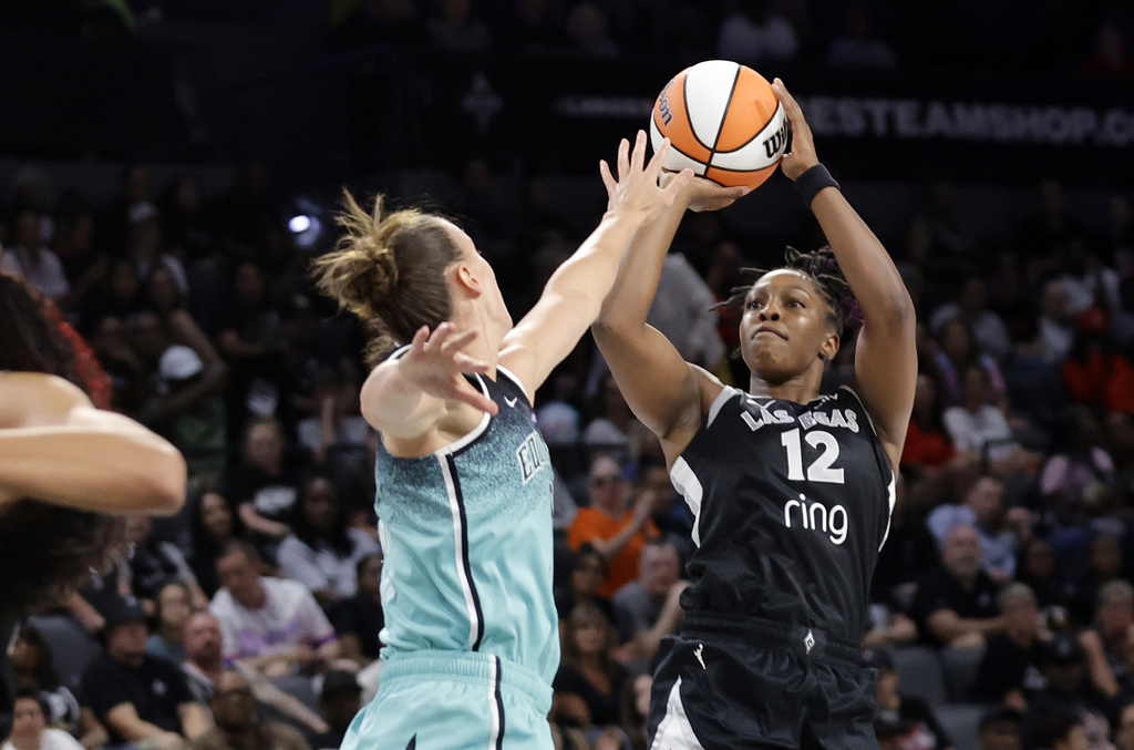 Las Vegas Aces guard Chelsea Gray (12) shoots over New York Liberty forward Stephanie Talbot during the first half of a WNBA basketball game, Wednesday, Aug. 13, 2025, in Las Vegas. (Steve Marcus/Las Vegas Sun via AP)