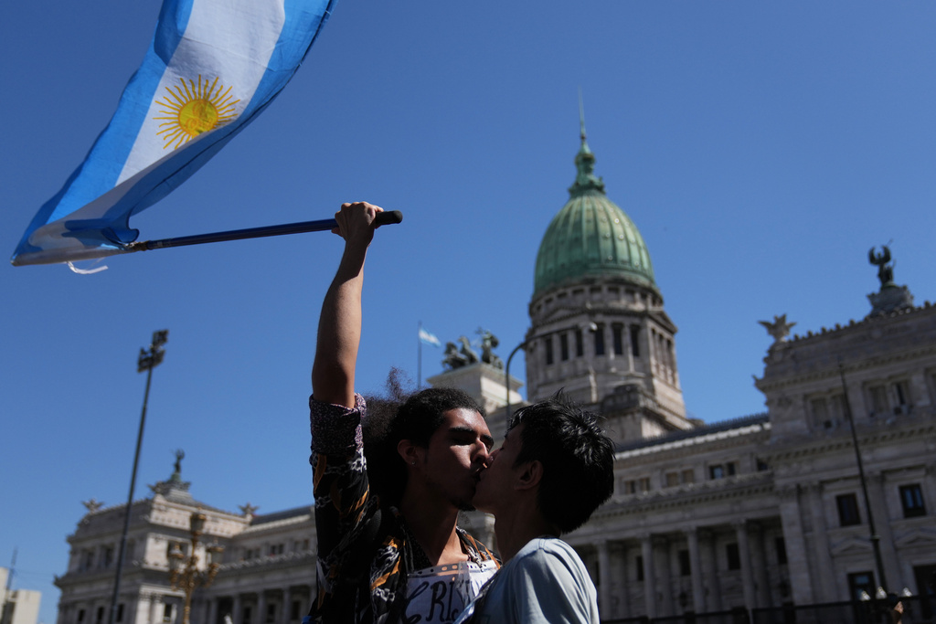 Cristian Valderrama kisses his husband Lucas Garcia during a protest outside Congress against a labor reform bill proposed by President Javier Milei's government in Buenos Aires, Argentina, Friday, Feb. 27, 2026. (AP Photo/Rodrigo Abd)