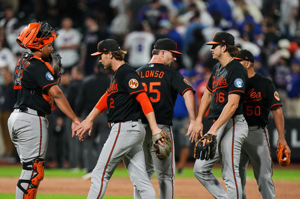 Baltimore Orioles' Gunnar Henderson (2), Pete Alonso (25) and Coby Mayo (16) celebrate with teammates after a baseball game against the New York Mets Monday, Sept. 14, 2026, in New York. (AP Photo/Frank Franklin II)