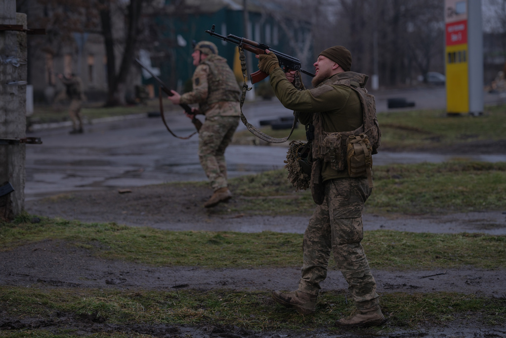 In this photo provided by Ukraine's 93rd Kholodnyi Yar Separate Mechanized Brigade press service, soldiers fire at a Russian FPV drone on the frontline in Druzhkivka, Donetsk region, Ukraine, Wednesday, Feb. 25, 2026. (Iryna Rybakova/Ukraine's 93rd Mechanized Brigade via AP)