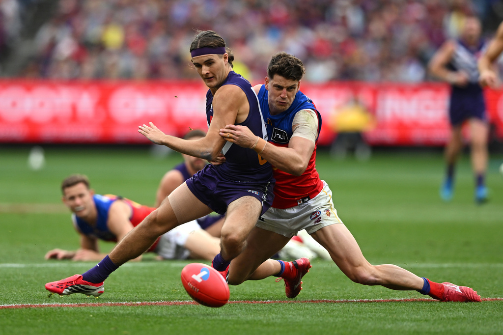 Murphy Reid of the Fremantle Dockers, left, is tackled by Jarrod Berry of the Brisbane Lions during the Australian Football League grand final in Melbourne, Australia Saturday, Sept. 26, 2026. (James Ross/AAP Image via AP)