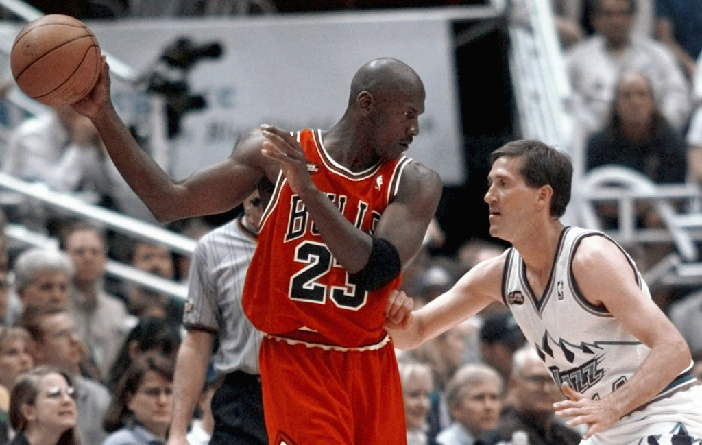 FILE - Chicago Bulls' Michael Jordan pulls the ball out of reach of Utah Jazz guard Jeff Hornacek during third quarter action in Game 2 of the NBA Finals in Salt Lake City, June 5, 1998. (AP Photo/Mark J. Terrill, file)