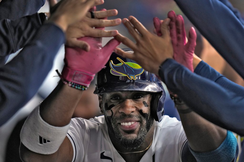 Tampa Bay Rays' Yandy DÌaz celebrates in the dugout after his solo home run off San Francisco Giants pitcher Robbie Ray during the second inning of a baseball game Friday, May 1, 2026, in St. Petersburg, Fla. (AP Photo/Chris O'Meara)