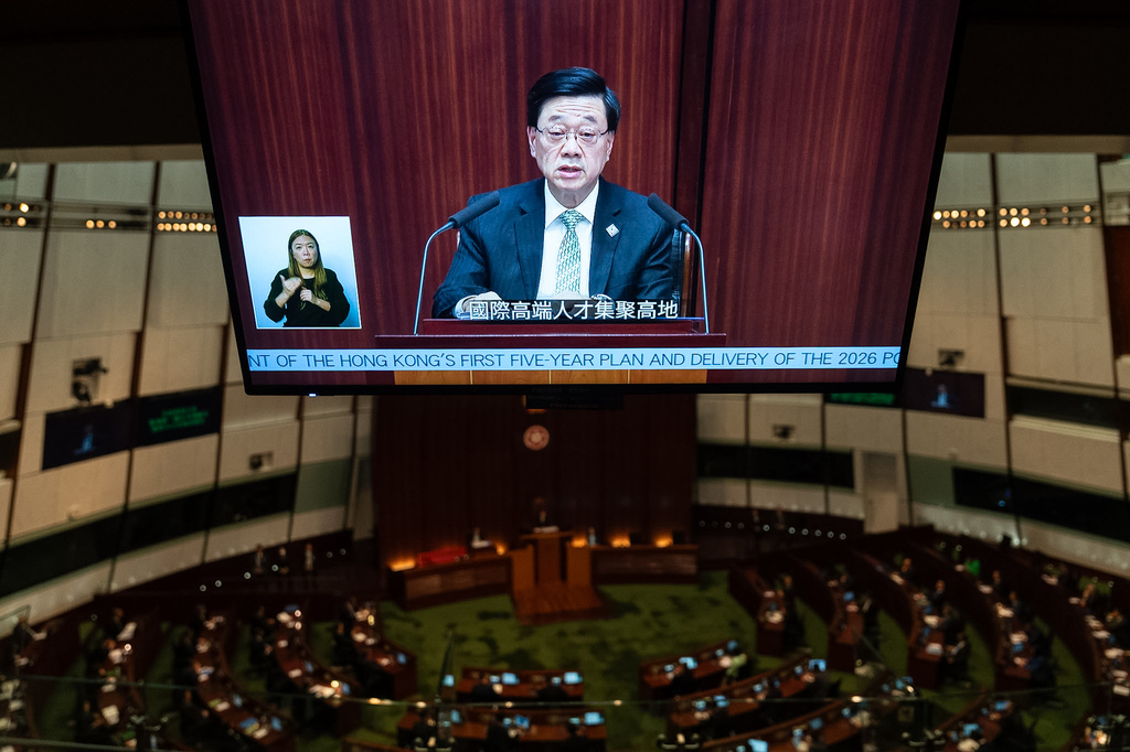 A television monitor shows Hong Kong's Chief Executive John Lee delivering the first Five-Year Plan and policy address at the Legislative Council in Hong Kong, Wednesday, Sept. 16, 2026. (AP Photo/Chan Long Hei)