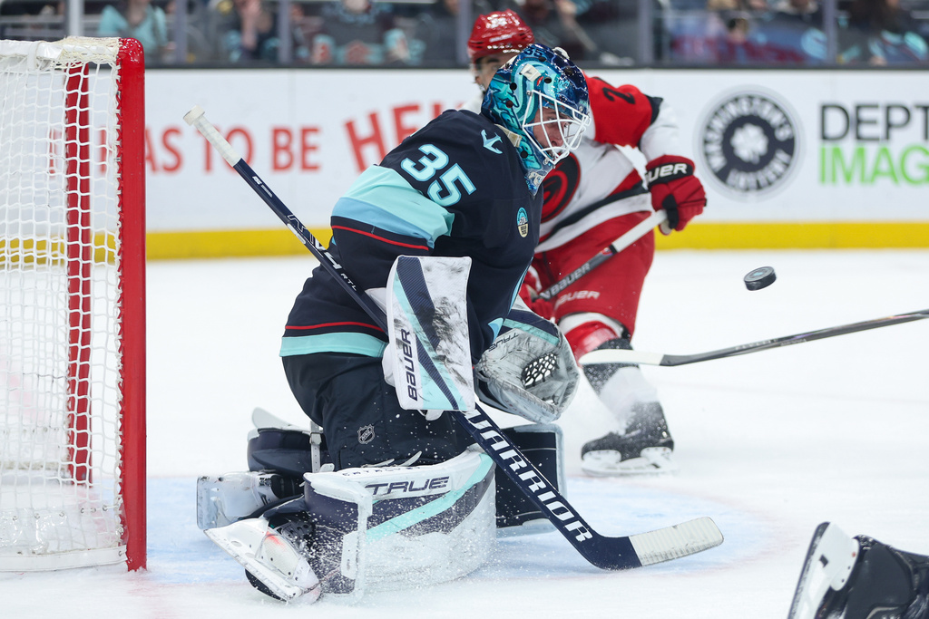 Seattle Kraken goalie Joey Daccord (35) blocks a shot on goal in the second period of an NHL hockey game against the Carolina Hurricanes, Monday, March 2, 2026, in Seattle. (AP Photo/Kevin Ng)