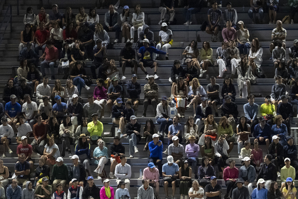 People watch a tennis match during the U.S. Open tennis championships at the USTA Billie Jean King National Tennis Center, Tuesday, Aug. 19, 2025, in New York. (AP Photo/Yuki Iwamura)