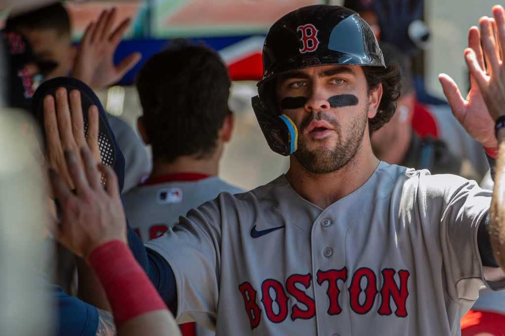 Boston Red Sox's Marcelo Mayer is congratulated after scoring on a sacrifice fly hit by Mickey Gasper during the fifth inning of a baseball game, Sunday, May 31, 2026, in Cleveland. (AP Photo/Phil Long)