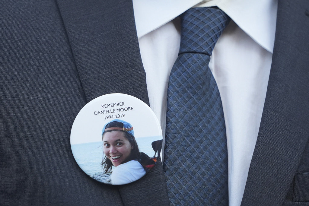 A family member wears a photo of a Boeing crash victim Danielle Moore before a hearing at federal court in Fort Worth, Texas, Wednesday, Sept. 3, 2025. (AP Photo/LM Otero)