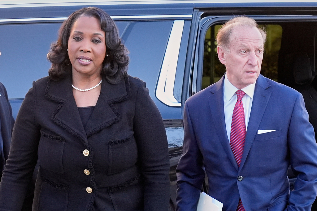 Federal Reserve governor Lisa Cook and attorney Abbe Lowell, arrive at the Supreme Court in Washington, Wednesday, Jan. 21, 2026. (AP Photo/Mark Schiefelbein)