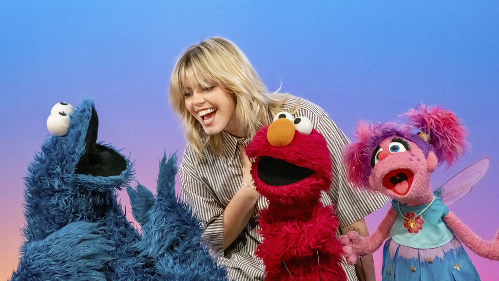 This image released by Sesame Workshop shows actor-singer Renee Rapp with muppet characters Cookie Monster, from left, Elmo and Abby Cadabby on the set of "Sesame Street." (Richard Termine/Sesame Workshop via AP)