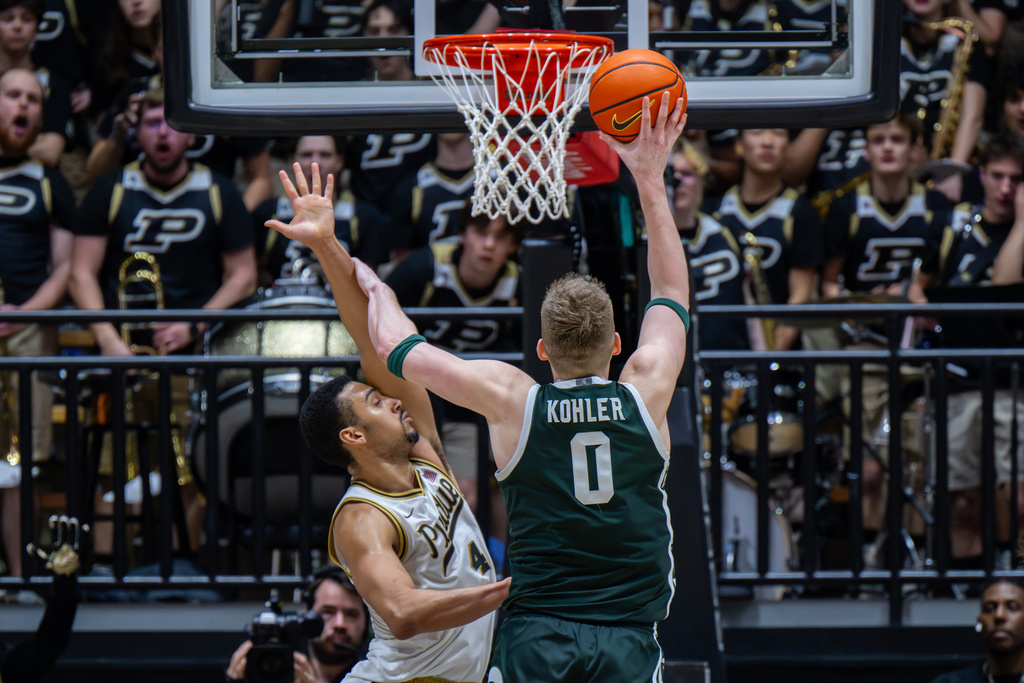 Michigan State forward Jaxon Kohler (0) brushes away the defense of Purdue forward Trey Kaufman-Renn (4) as he shoots during the second half of an NCAA college basketball game, Thursday, Feb. 26, 2026, in West Lafayette, Ind. (AP Photo/Doug McSchooler)