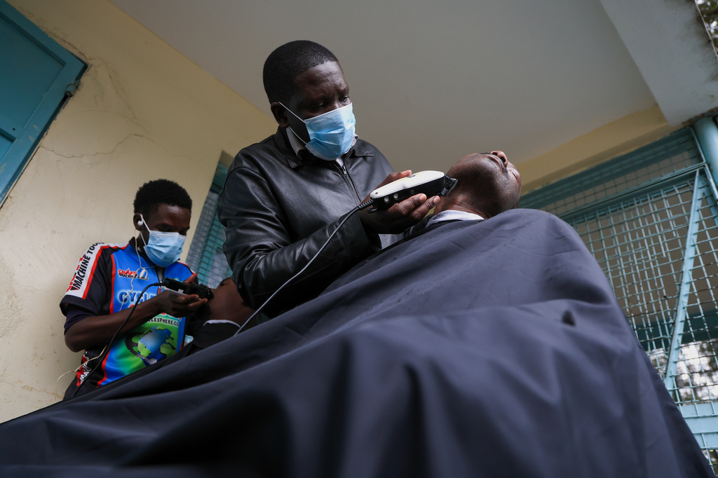 Barbers shave patients hair during a grooming session at the largest mental health referral hospital, Mathari in Nairobi, Kenya, Tuesday, June 30, 2026. (AP Photo/Andrew Kasuku)